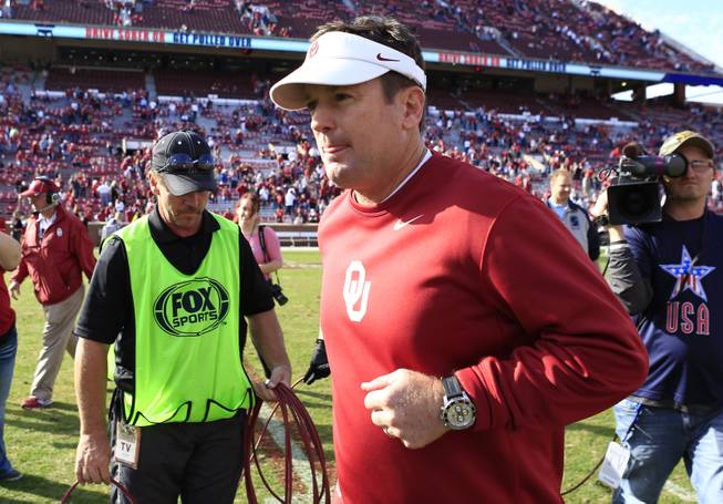 Oklahoma head coach Bob Stoops runs to the locker room after defeating Iowa State 48-10 in an NCAA college football game in Norman, Okla. on Saturday, Nov. 16, 2013. 