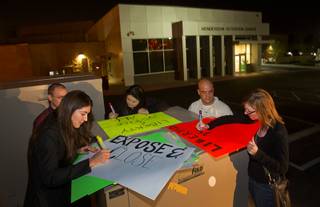 Katelyn Cantu, left, Alissa Cooley, center, and Katelyn Franklin make signs outside the Henderson Detention Center Tuesday, Nov. 19, 2013. Protesters are concerned about a UNLV law clinic report that raises questions about the conditions for immigrants at the detention center.