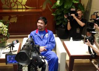 Manny Pacquiao takes a break as he is interviewed after his 