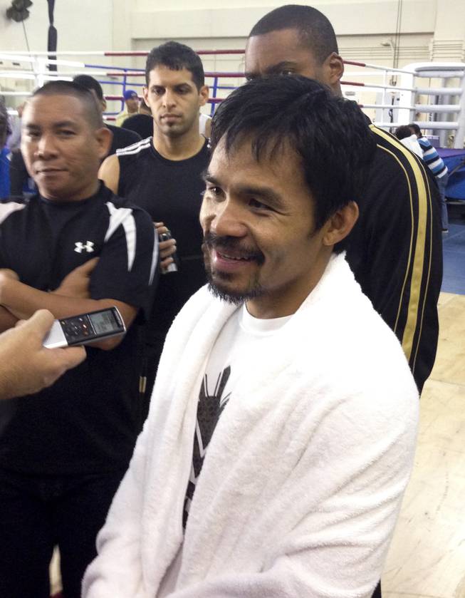 Manny Pacquiao talks to reporters after a workout as he preps to fight.Brandon Rios on Saturday night at Cotai Arena at Venetian Macau Tuesday, Nov. 2013.