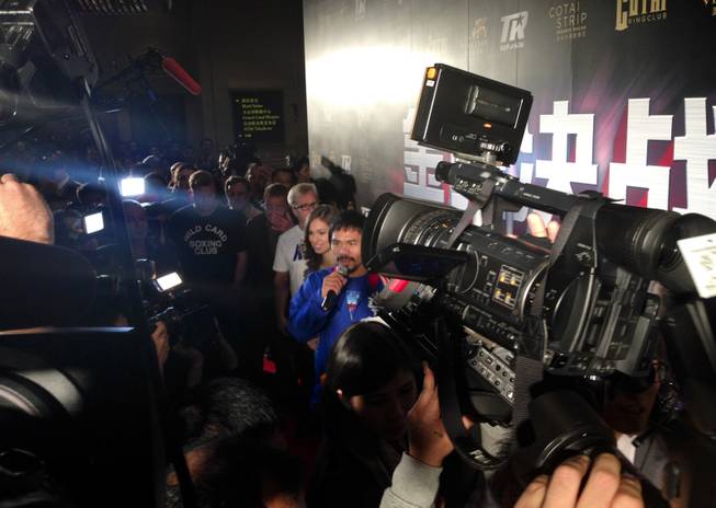 Manny Pacquiao is interview amid a crush of fans at Venetian Macau on Tuesday, Nov. 19, 2013.