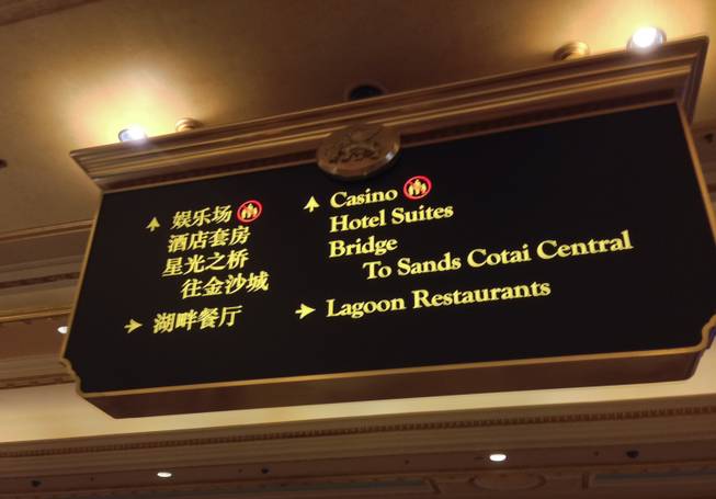 The signs are bilingual at Venetian Macau, but not all of the employees are, Tuesday, Nov. 19, 2013.