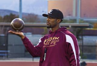 Faith Lutheran football coach Vernon Fox, a former NFL player who is known for his legendary motivational speeches, keeps an eye on his players during practice Tuesday, Nov. 19, 2013. 