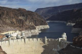A view of Hoover Dam and Lake Mead on Wednesday, Dec. 18, 2013, near Boulder City shows canyon walls ringed with white mineral deposits indicating the drop in water levels.