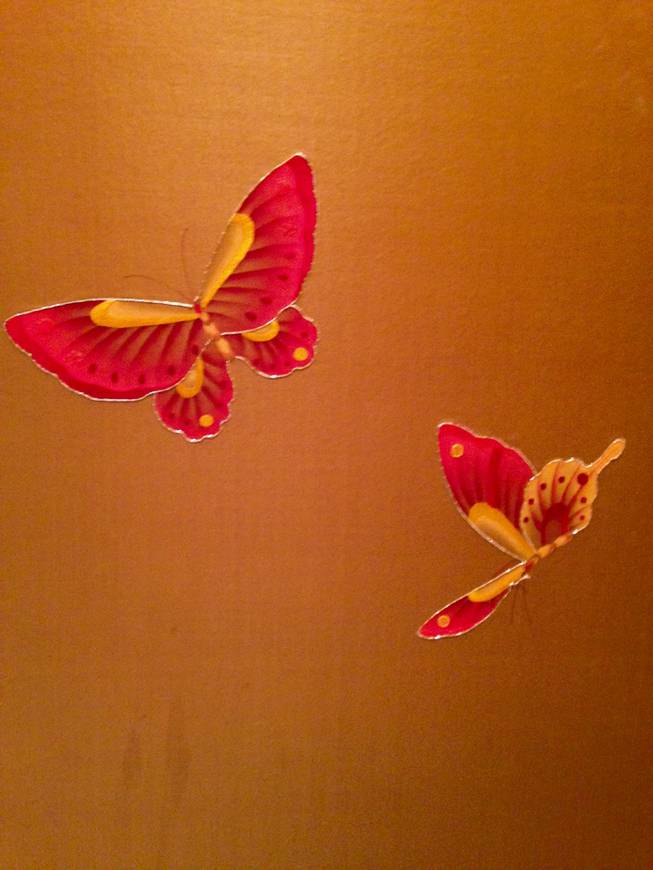 Butterflies stitched into the fabric walls of the elevators at Wynn.Macau.