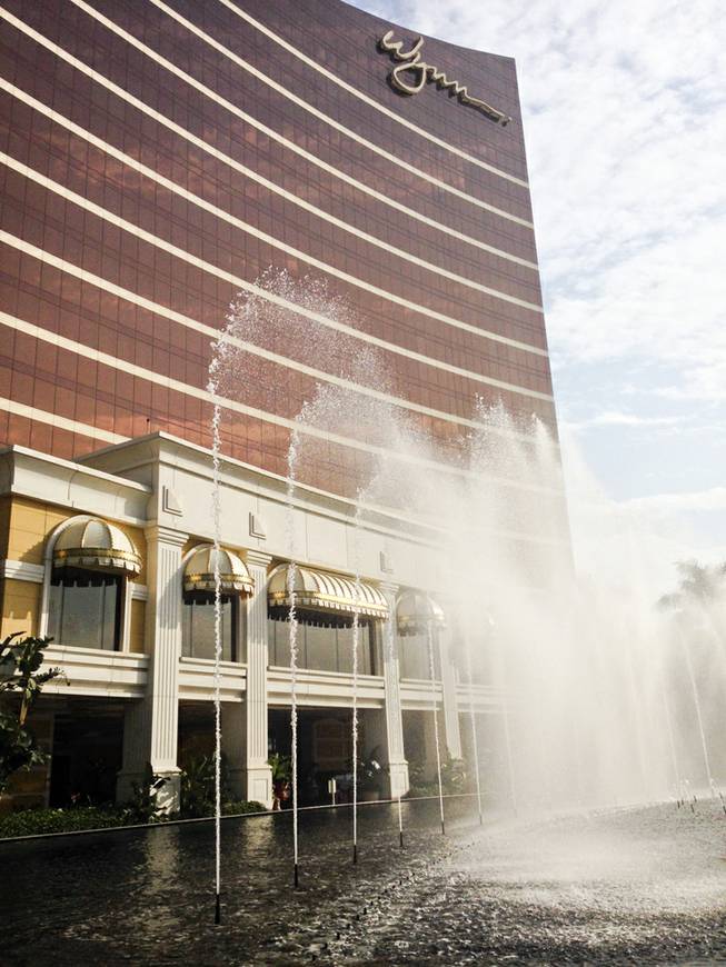 Water sprays the entrance of Wynn Macau.