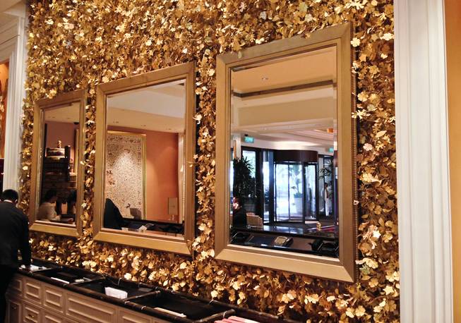 The gold-leaf, mirrored effect behind the registration desk of Wynn.Macau.