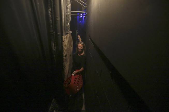 Squeezing through a tight space behind the stage, show dresser Paula Nyland preps for &quot;Vegas! The Show&quot; at the Saxe Theater in Las Vegas.