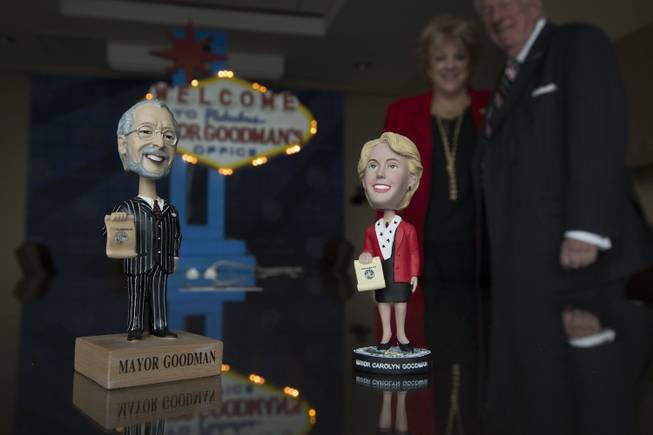 Las Vegas Mayor Carolyn Goodman, background left, happily works in the shadow of her predecessor and husband, former Mayor Oscar Goodman, Nov. 21, 2013. Oscar has nearly 80 different bobble head dolls made in his image, Carolyn has one.