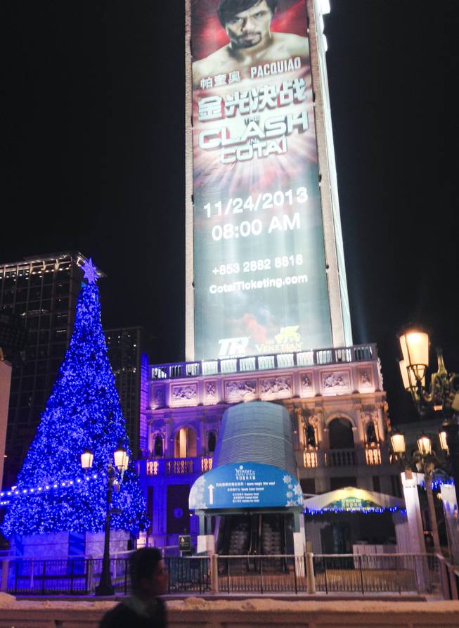 A giant Pacquiao vs Rios fight ad is seen behind the Venetian Macau Christmas tree on display outside the property.
