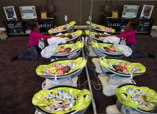 Evonne Derrico tends to her infant quintuplets as they sleep Monday, Nov. 22, 2013.