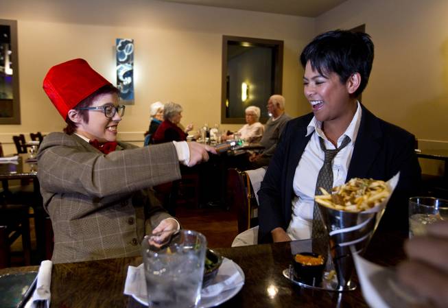 Jenny Stiles, left, and friend Carmel Viado, dressed as Dr. Who characters, joke around during dinner at Bachi Burger Monday, Nov. 25, 2013.
