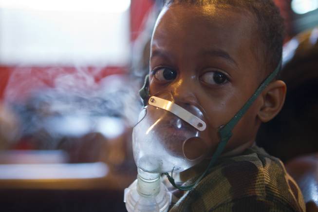 Derrick Derrico, 3, spends time on a vaporizer to stave off a cold as the quintuplets are at a high risk of getting sick on Thursday, Nov. 25, 2013.