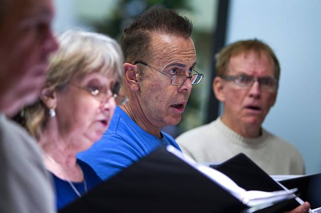 Aaron Schave, center, and members of the Myron Heaton Chorale rehearse at Christ the Servant Lutheran Church in Henderson Tuesday, Nov. 26, 2013. The Chorale are scheduled to perform at the church on Dec. 8.