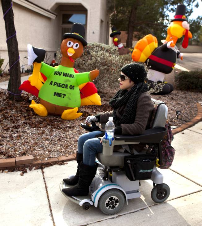 Jenny Stiles takes a stroll in a motorized wheelchair around the neighborhood Thursday, Nov. 28, 2013.  Due to depleted energy levels from her triweekly dialysis sessions Jenny is unable to walk for long periods of time.