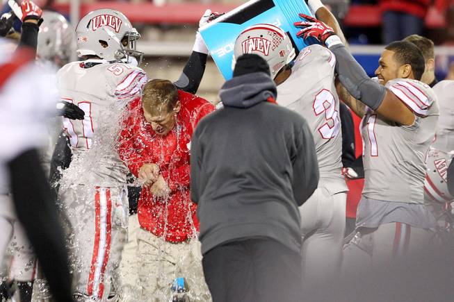 UNLV head coach Bobby Hauck gets an ice water bath as time runs out during their Mountain West Conference game against  San Diego State Saturday, Nov. 30, 2013 at Sam Boyd Stadium. UNLV won 45-19.