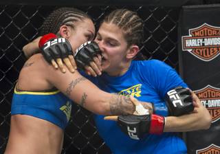 (From left) Raquel Pennington gets in the face of her opponent  Roxanne Modafferi during their women's bantamweight TUF 18 finale bout at the Mandalay Bay Events Center on Saturday, Nov. 30, 2013.
