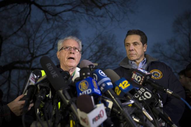 National Transportation Safety Board board member Earl Weener speaks during a news conference alongside New York Governor Andrew Cuomo, right, at the scene of a Metro-North passenger train derailment in the Bronx borough of New York, Sunday, Dec. 1, 2013. The train derailed on a curved section of track in the Bronx on Sunday morning, coming to rest just inches from the water and causing multiple fatalities and dozens of injuries, authorities said. Metropolitan Transportation Authority police say the train derailed near the Spuyten Duyvil station.