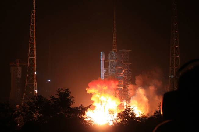 In this photo released by China's Xinhua News Agency, the Long March 3B rocket carrying the Chang'e-3 lunar probe blasts off from the launch pad at Xichang Satellite Launch Center, southwest China's Sichuan Province, Monday Dec. 2, 2013. It will be the first time for China to send a spacecraft to soft land on the surface of an extraterrestrial body, where it will conduct surveys on the moon.