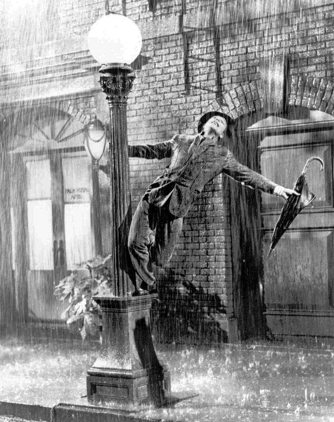 In this undated file photo, Gene Kelly performs in the 1952 film "Singin' in the Rain." The gray wool suit Kelly wore in the movie is going up for auction after being kept in a closet by a memorabilia collector for more than four decades.