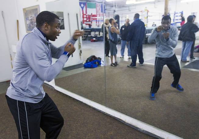 Lightweight boxer Rashad Ganaway shadow boxes in front of a mirror during a workout at the Pochiro Boxing gym Tuesday, Dec. 3, 2013. Pochiro Boxing Promotions will hold a boxing card featuring local boxers at Sam's Town Friday. Ganaway is preparing for a February card.