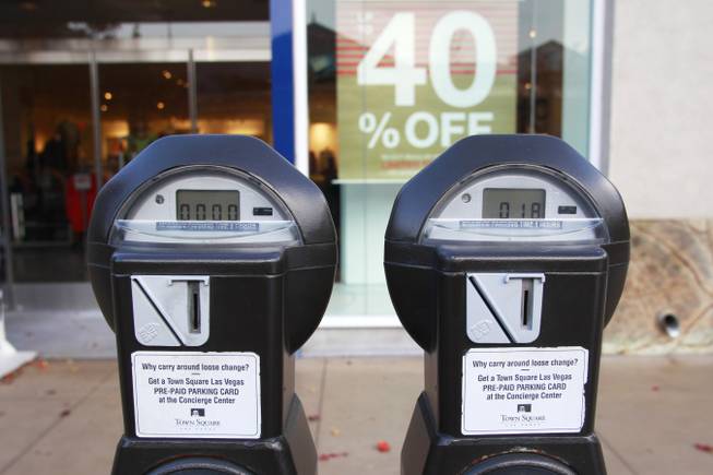 Parking meters are seen in the Town Square shopping center Tuesday, Dec. 3, 2013.
