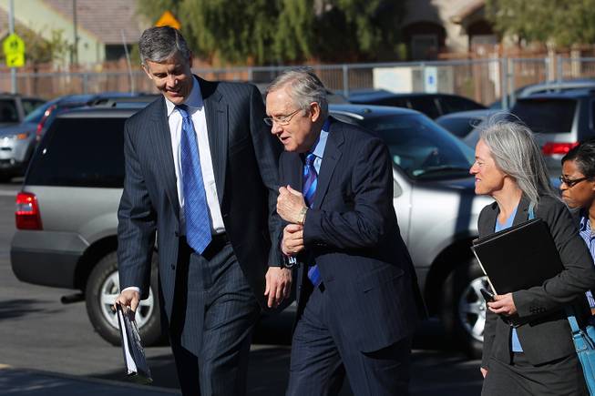 U.S. Secretary of Education Arne Duncan and Senate Majority Leader Harry Reid arrive for a visit to Walter Bracken Elementary School Wednesday, Dec. 4, 2013. Duncan also took part in a roundtable discussion with various school district principals.