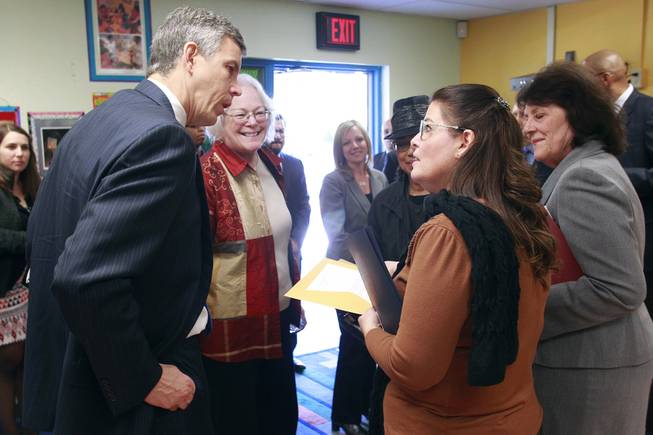 U.S. Secretary of Education Arne Duncan talks with Walter Bracken Elementary School principal Katie Decker during visit to the school Wednesday, Dec. 4, 2013. Duncan also took part in a roundtable discussion with various school district principals.