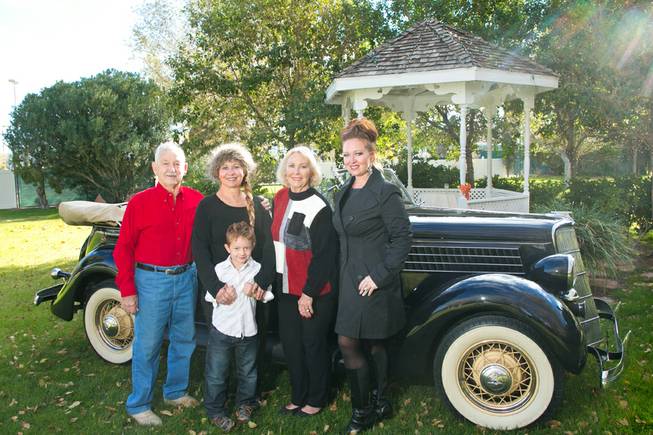 From left: John Miller, daughter Christi McKee, great grandson Rocco Mills, Ann Miller, grand daughter Erin Mills, pose for a photo in front of a 39 Ford at their family owned wedding venue the Secret Garden, Wednesday, Dec. 4, 2013.