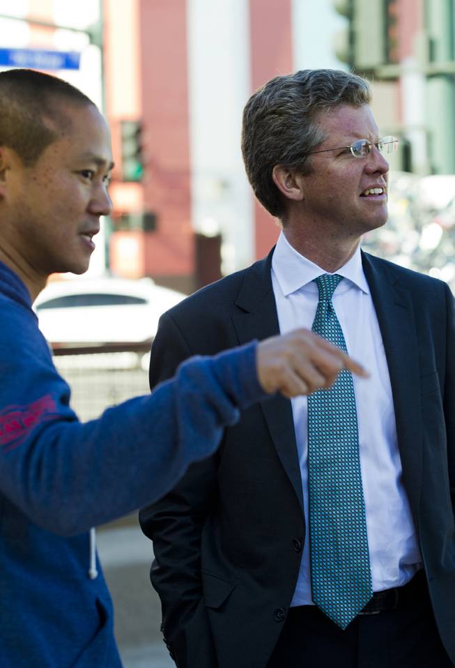 Zappos CEO Tony Hsieh, left, explains the concept of the Container Park to Shaun Donovan, U.S. Department of Housing and Urban Development secretary, as they tour downtown Wednesday, Dec. 4, 2013.
