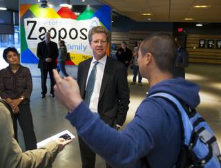 Shaun Donovan, secretary of the U.S. Department of Housing and Urban Development, center, begins a tour of downtown Las Vegas by meeting Tony Hsieh at Zappos on Wednesday, Dec. 4, 2013.