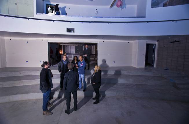 Zappos CEO Tony Hsieh, center, speaks to Shaun Donovan, U.S. Department of Housing and Urban Development secretary, about the progress at Inspire Theater, which is currently under construction, on Wednesday, Dec. 4, 2013.
