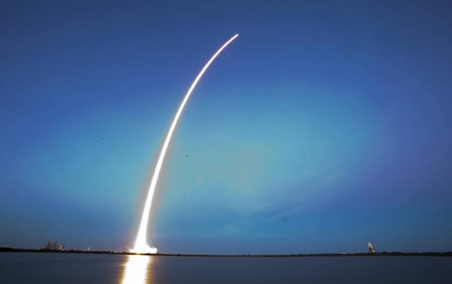 A Falcon 9 SpaceX rocket lifts off from Launch Complex 40 at the Cape Canaveral Air Force Station in Cape Canaveral, Fla., Tuesday, Dec. 3, 2013. The rocket is carrying its first commercial payload, a communications satellite.