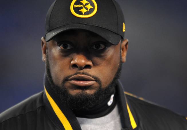 In this Nov. 28, 2013, file photo, Pittsburgh Steelers head coach Mike Tomlin watches his players warm up before an NFL football game against the Baltimore Ravens.