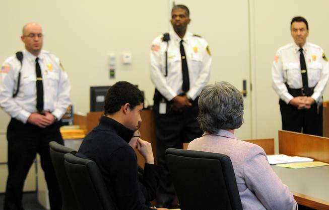 Phillip Chism, second from left, 14, from Danvers, sits with his attorneys during his arraignment in Salem Superior Court, Wednesday, Dec. 4, 2013, in Salem, Mass. Chism is charged in the Oct. 22 killing of a popular Danvers High School math teacher Colleen Ritzer. He pleaded not guilty to murder, aggravated rape and armed robbery charges Wednesday. He will remain held without bail.