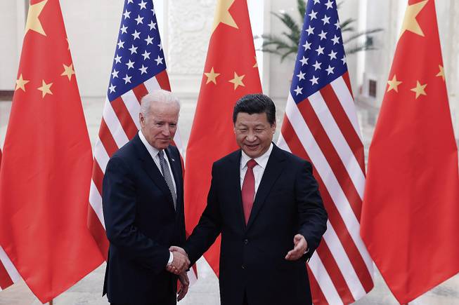 Chinese President Xi Jinping, right, shakes hands with U.S Vice President Joe Biden as they pose for photos at the Great Hall of the People in Beijing, China, Wednesday, Dec. 4, 2013.
