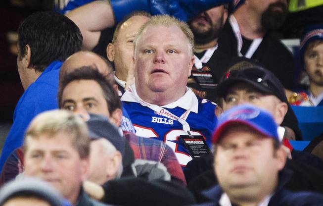 Toronto Mayor Rob Ford watches the Buffalo Bills play the Atlanta Falcons during the first half of an NFL football game, in Toronto, Dec. 1, 2013. 