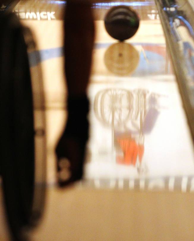 The American Wheelchair Bowling Association logo is reflected in a land during the AWBA Las Vegas Invitational tournament's doubles event Thursday, Dec. 5, 2013 at Texas Station.