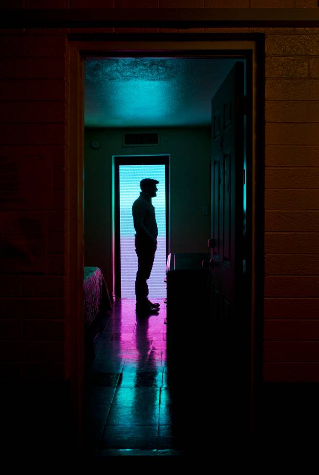 Artist Brian Henry stands silhouetted by his installation during the Greetings from Las Vegas pop-up gallery at the Gateway Motel on Thursday,  Dec. 5, 2013.