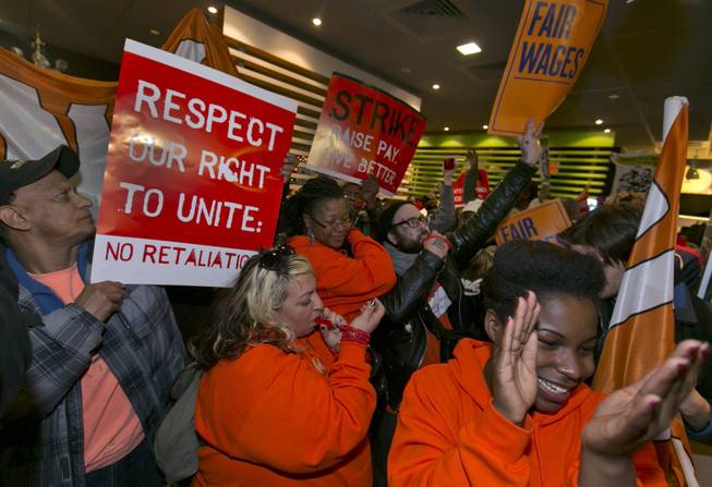 Demonstrators rally for better wages inside a McDonald's restaurant in New York, as part of a national protest, Thursday, Dec. 5, 2013. Demonstrations planned in 100 cities are part of push by labor unions, worker advocacy groups and Democrats to raise the federal minimum wage of $7.25. 