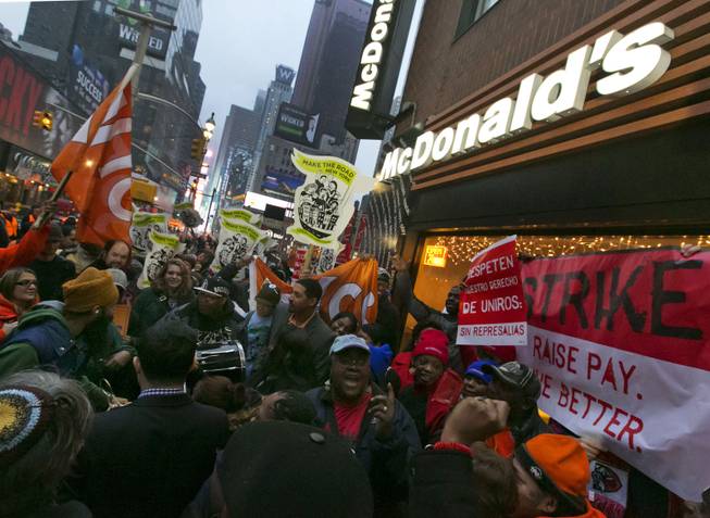 Demonstrators rally for better wages outside a McDonald's restaurant in New York, as part of a national protest, Thursday, Dec. 5, 2013. Demonstrations planned in 100 cities are part of push by labor unions, worker advocacy groups and Democrats to raise the federal minimum wage of $7.25.