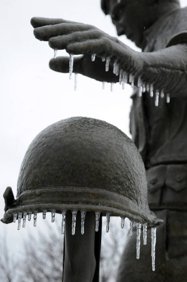 Ice hangs from a statue in Mountain Home, Ark., on Thursday, Dec. 5, 2013. A mix of rain,sleet and snow moved through northern Arkansas on Thursday. More is expected Friday.