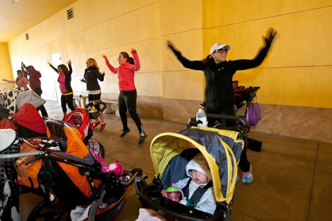 Instructor Jessica Peralta encourages her moms and moms-to-be while doing jumping jacks during the Stoller Strides class, a program offered by FIT4MOM Las Vegas, at Town Square Mall in Las Vegas Friday morning, December 6, 2013.