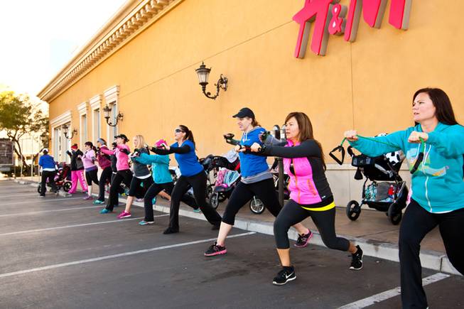Moms and moms-to-be perform resistance stretches and lunges during the Stoller Strides class, a program offered by FIT4MOM Las Vegas, Friday morning, December 6, 2013, at Town Square Mall in Las Vegas.