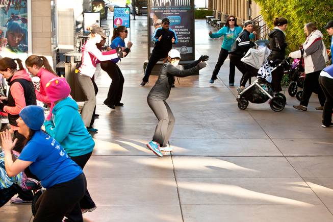 Instructor Jessica Peralta works out with moms and their babies during the Stoller Strides class, a program offered by FIT4MOM Las Vegas, at Town Square Mall in Las Vegas Friday morning, December 6, 2013.