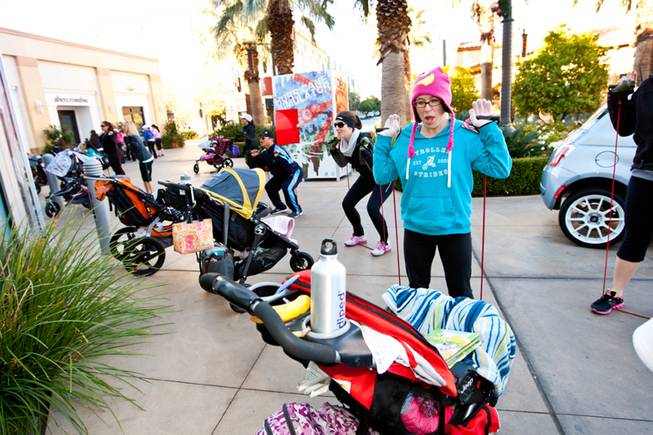 Keely Lindquist sings to her baby while working out during the Stoller Strides class, a program offered by FIT4MOM Las Vegas, at Town Square Mall in Las Vegas Friday morning, December 6, 2013.
