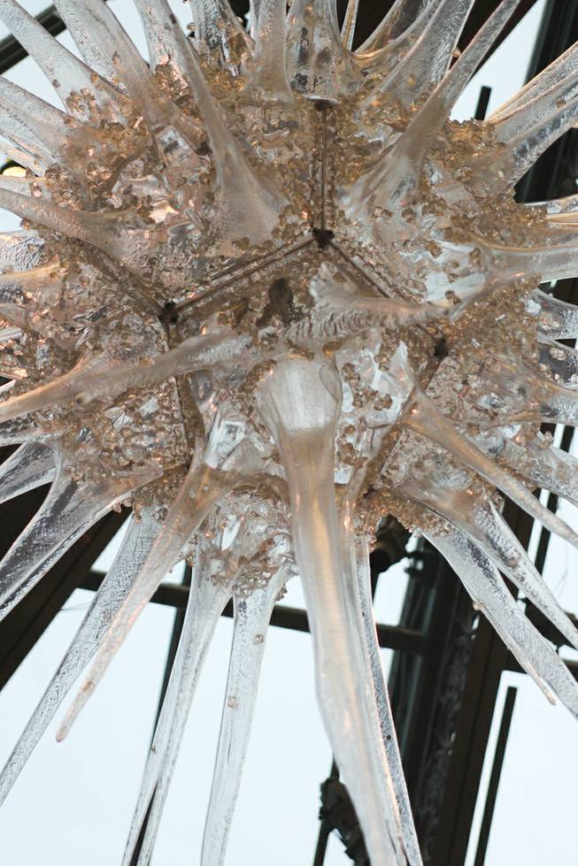 Large icicle sculptures hang from the ceiling at the Bellagio Conservatory during the tree lighting ceremony Friday, Dec. 6, 2013.