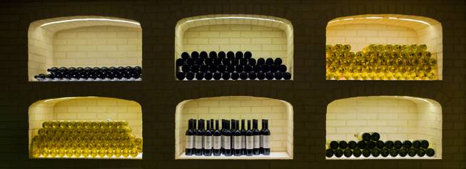 Bottles of wine are stacked in the back room of the new restaurant Crush at MGM Grand on Friday,  Dec. 6, 2013.  
