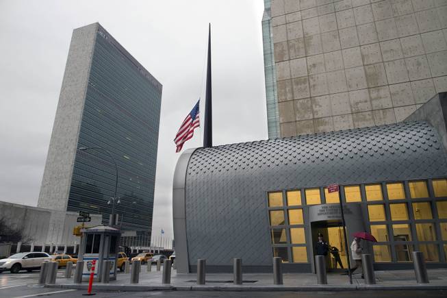 The U.S. flag flies at half staff in honor of South African leader Nelson Mandela, Friday, Dec. 6, 2013, at the U.S Department of State offices near the United Nations in New York. South Africa's first black president died Thursday after a long illness. He was 95.