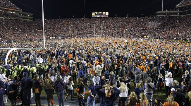 Auburn fans react at the end of a win over Alabama during the second half of an NCAA college football game in Auburn, Ala., Saturday, Nov. 30, 2013. Auburn beat Alabama 34-28.